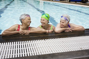 three smiling women in swimming pool