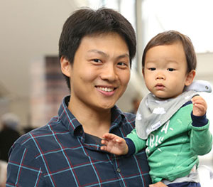 smiling man holding baby