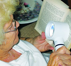 Woman using magnifying reading device