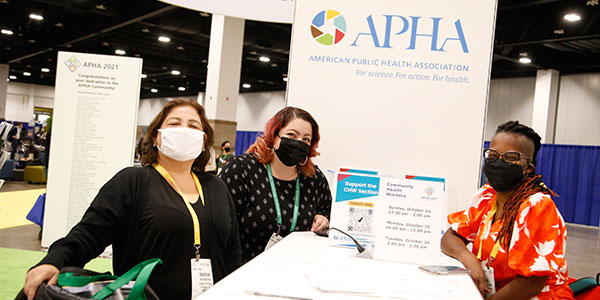 three women at APHA table at Public Health Expo