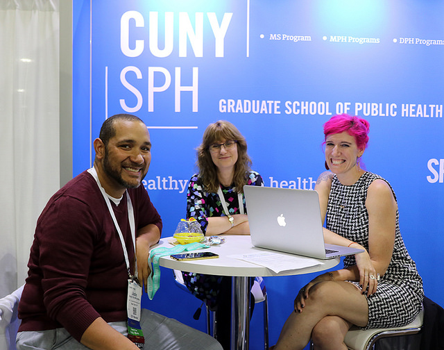 three people seated at Expo booth table
