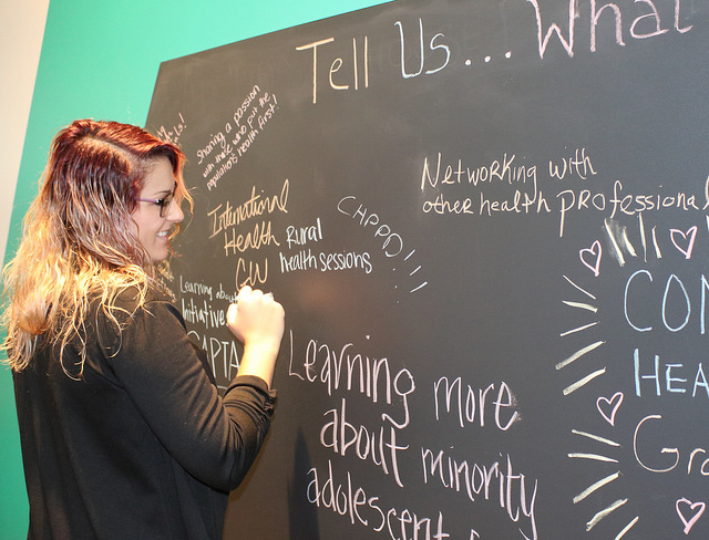 woman writing on chalkboard