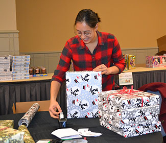 woman wrapping gifts
