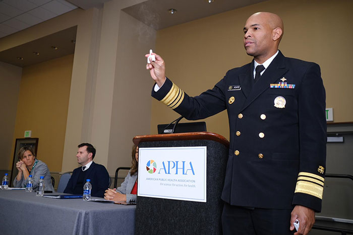 Surgeon General Jerome Adams demonstrating naloxone nasal spray