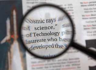 Newspaper with magnifying glass