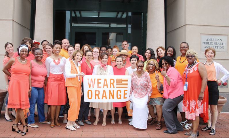 APHA staff in orange, with Wear Orange sign