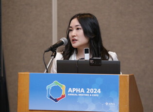 Woman speaking at podium at APHA 2024