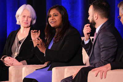 Shelley Hearne, Soma Saha and two men seated on stage