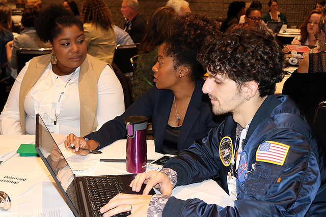 women talking and man on laptop