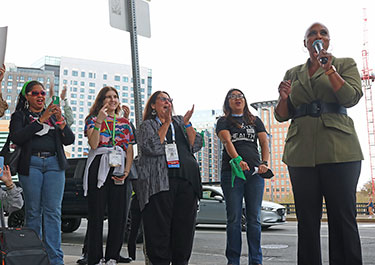 U.S. Rep. Ayanna Pressley speaks at the reproductive rights rally while APHA members cheer and clap next to her. 