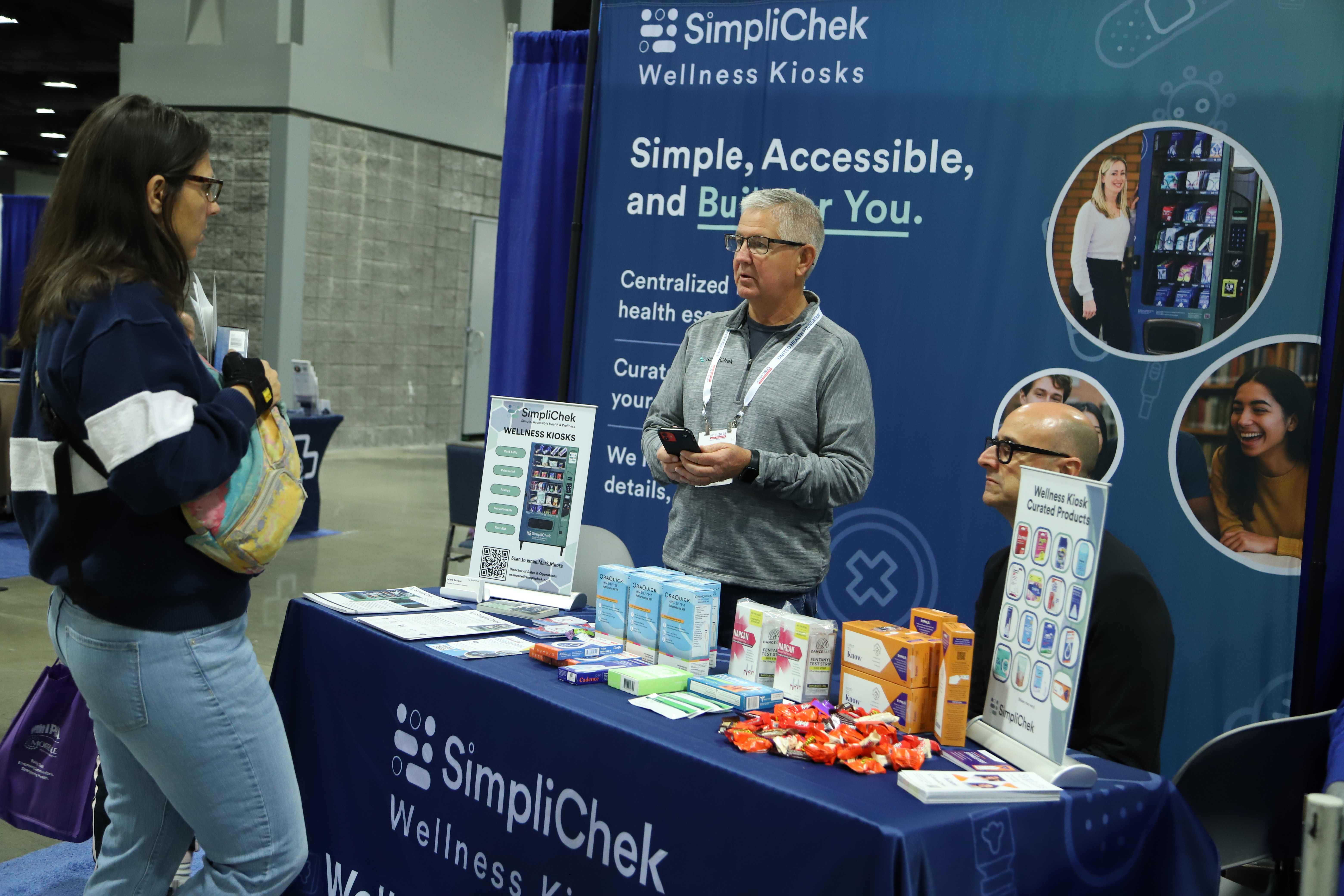 Photo of an exhibitor at the 2025 Annual Meeting. Three people are standing at a table. 