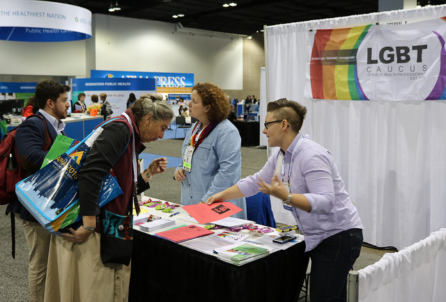 attendees at LGBT Caucus booth