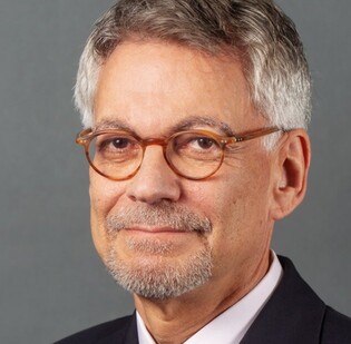 Headshot of John Auerbach