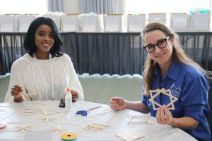 two smiling women at craft table