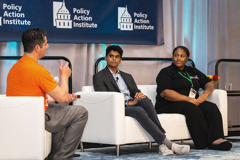 Three people at a conference