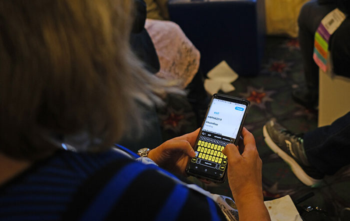 woman looking at mobile phone #APHA2019