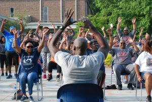 man leading seated chair exercise class