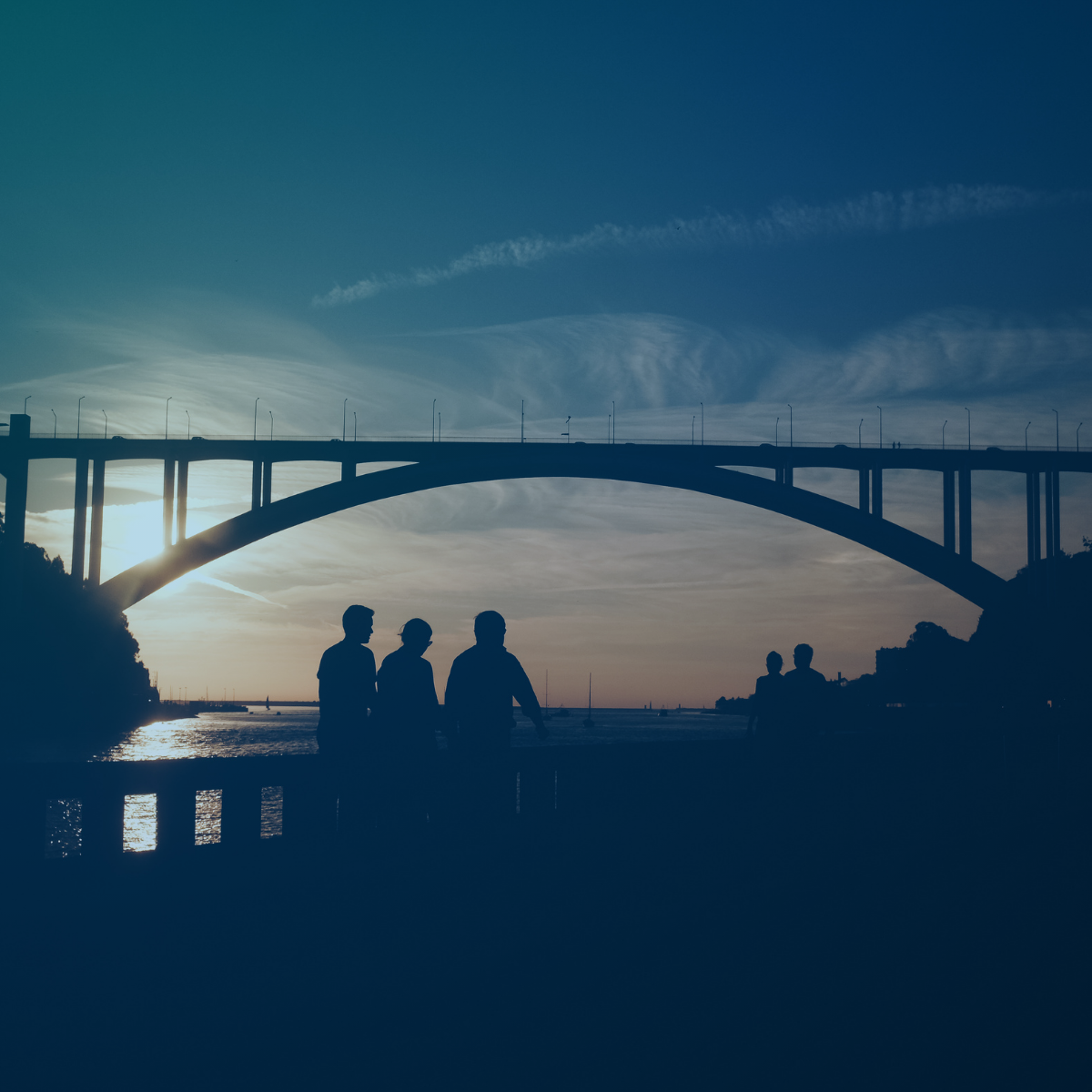 Bridge with people walking under it 