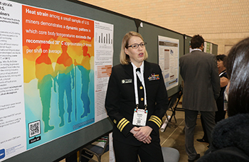 uniformed woman talking about public health poster
