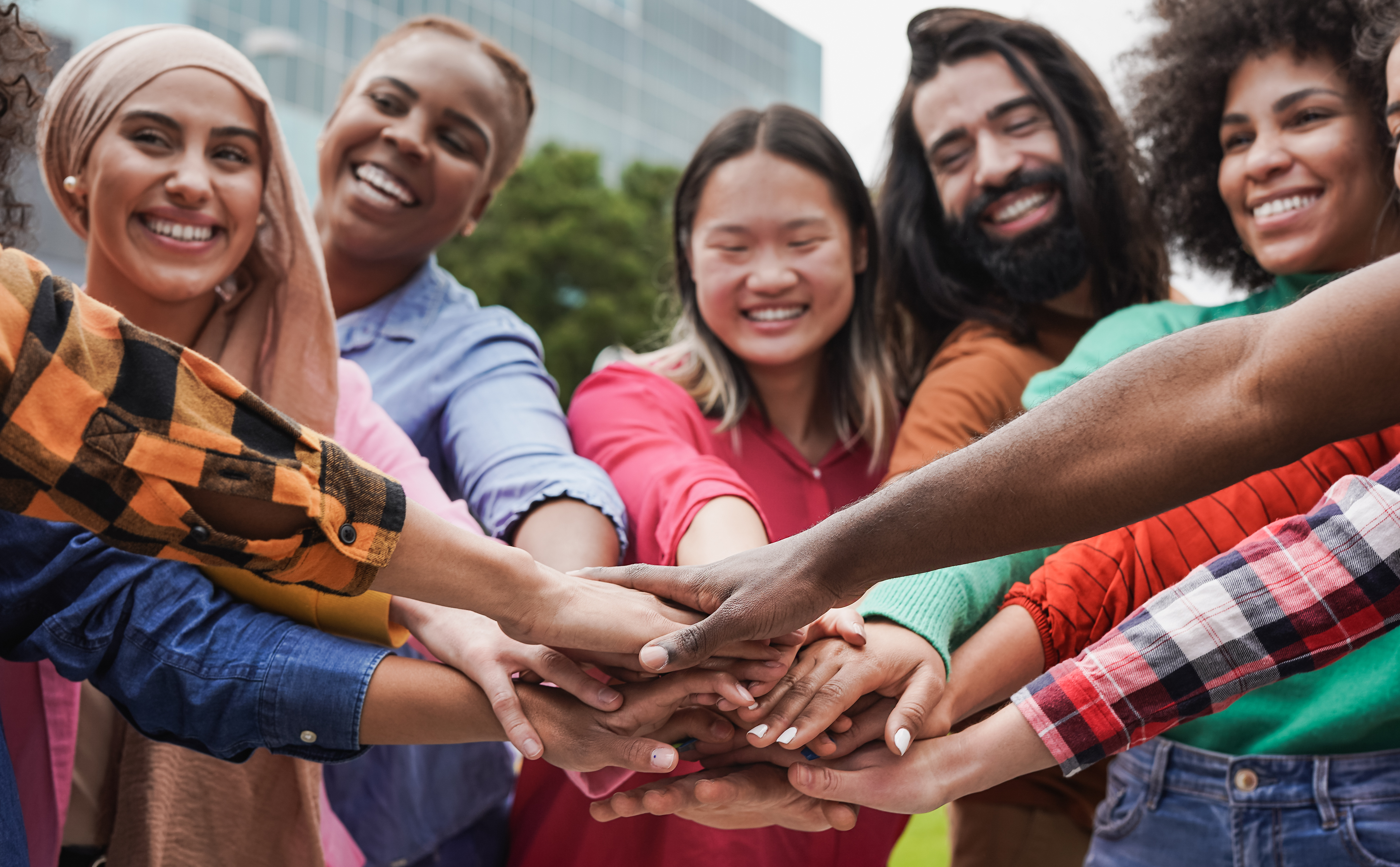 People of different races and ethnicities smile at camera