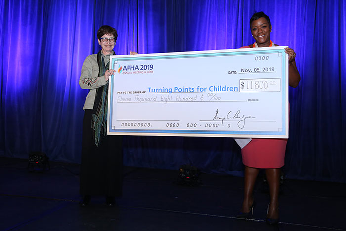 Gail Bellamy presenting giant check to Turning Points for Children representative