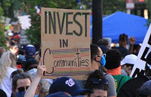 Invest in Communities protest sign
