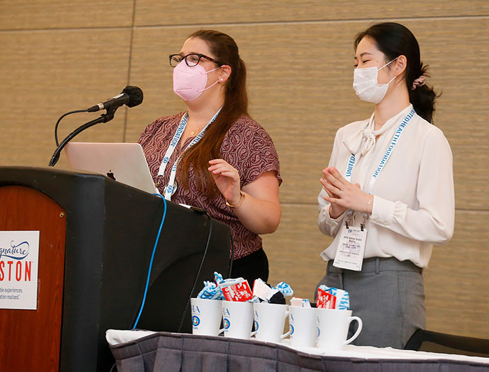 A student stands at the podium while a colleague looks on during Saturday's National Student Meeting. 