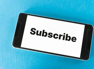 Phone with the word subscribe on it