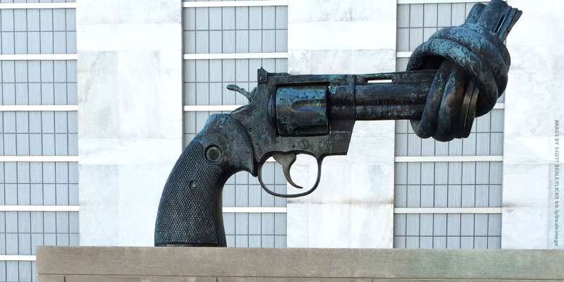 statue of handgun with barrel tied in knot