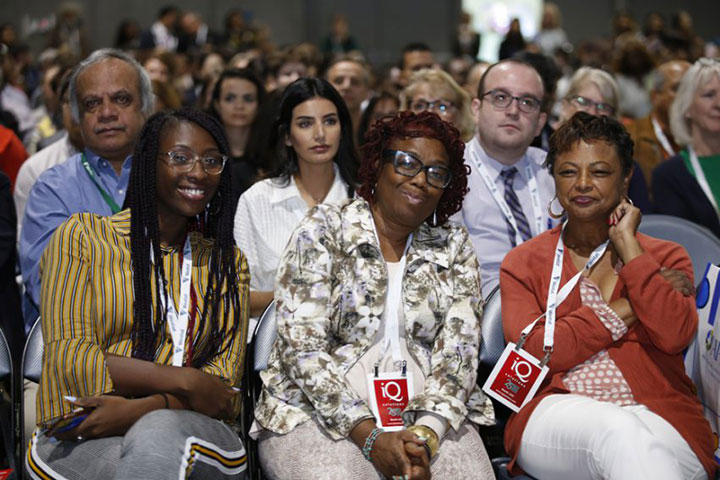 three smiling women seated at Annual Meeting session