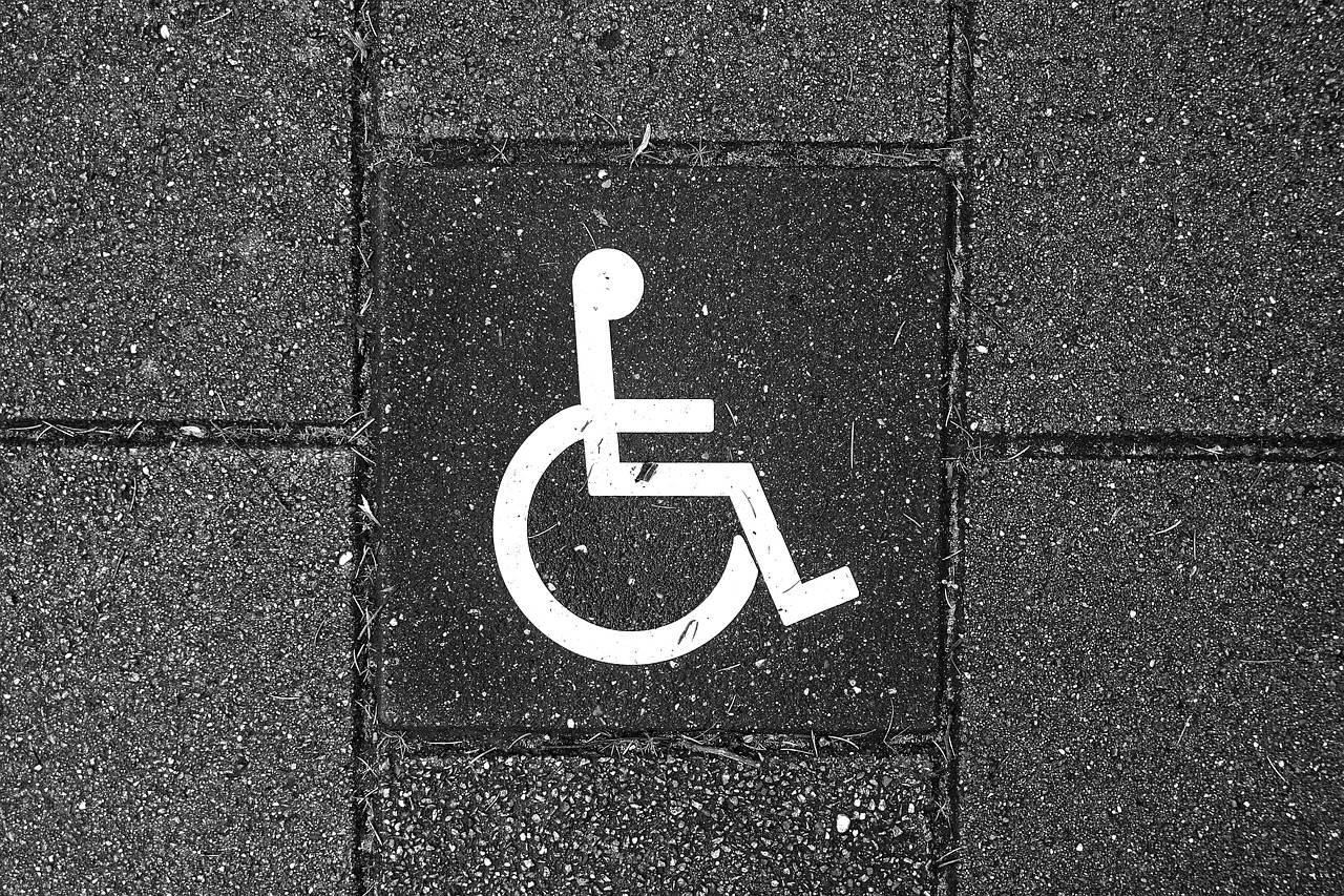 White wheelchair symbol on black tiles