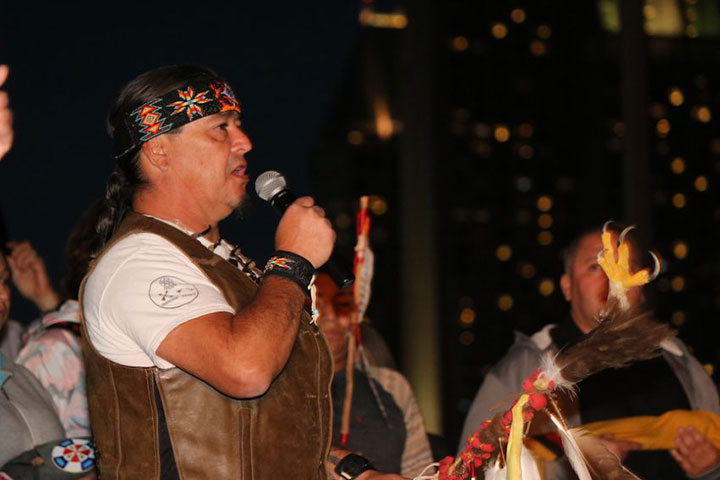 Native American man speaking into microphone