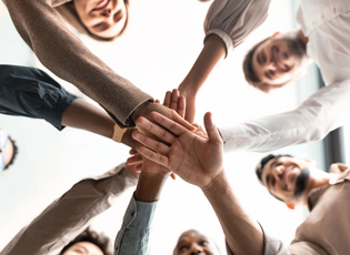 Diverse business people putting their hands together in circle stock photo