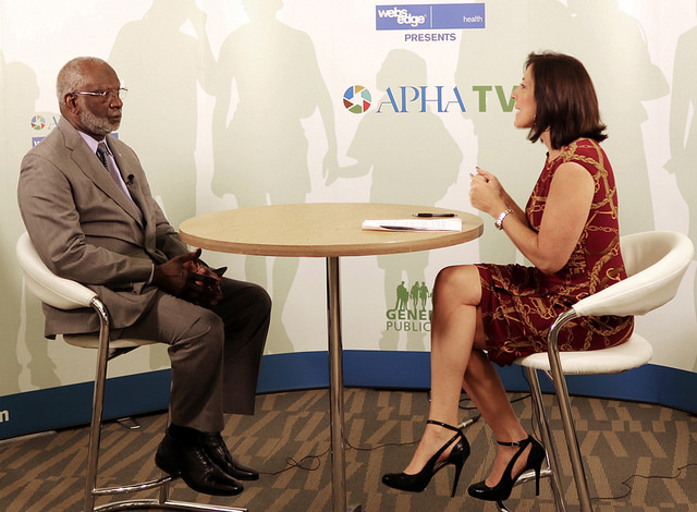 David Satcher being interviewed by woman at APHA TV table