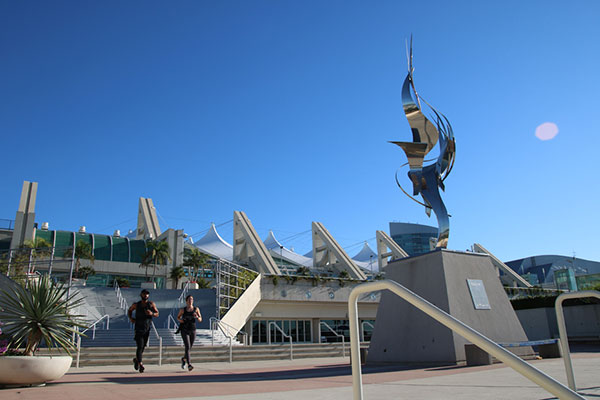 two joggers in front of San Diego Convention Center