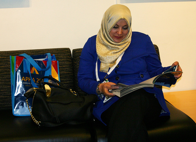woman perusing Annual Meeting program