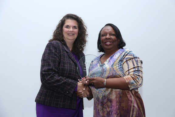 two women holding award
