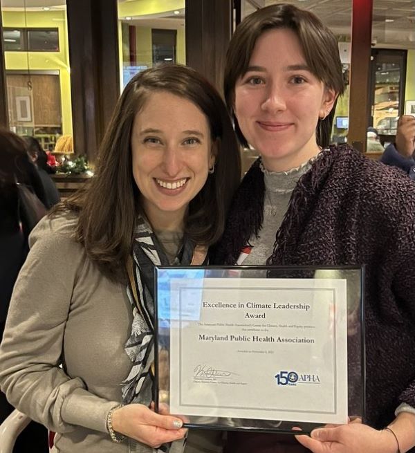 Two members of the Maryland Public Health Association posing with an award for Excellence in Climate Leadership