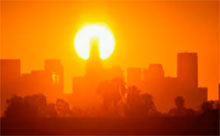 smoggy city skyline at sunset