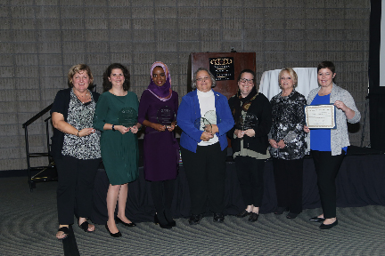 seven women showing awards