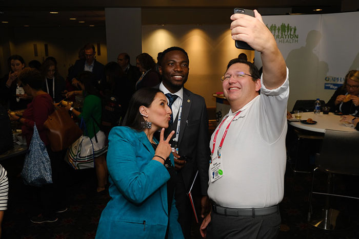 Brian Castrucci taking selfie with man and woman