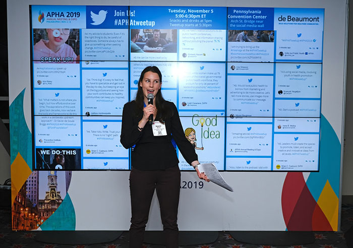 woman in front of social media wall
