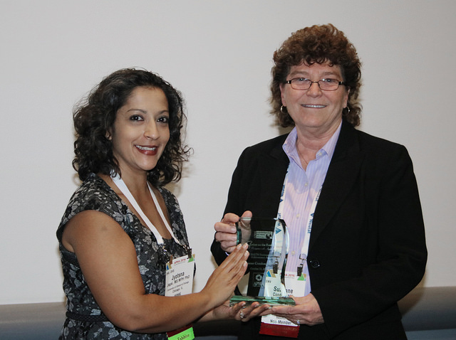 smiling women with crystal award