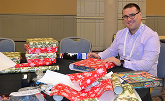 man wrapping gifts