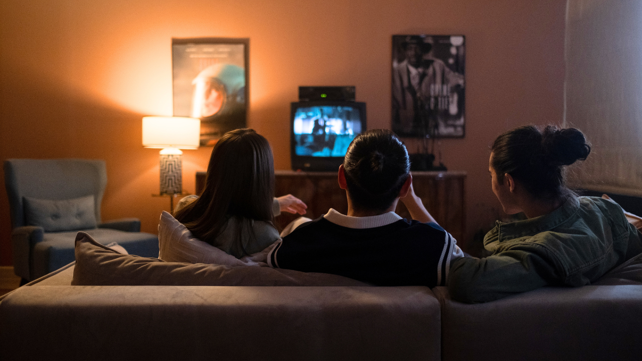 A family watching a movie on their couch 