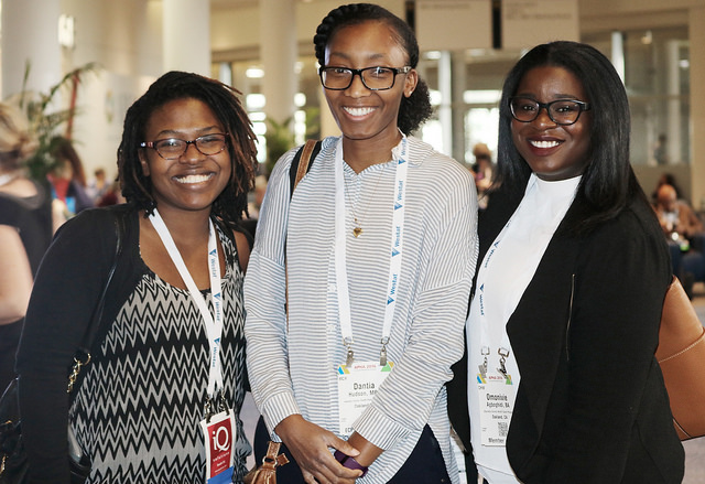 three smiling women wearing Annual Meeting name badges