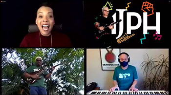 woman singing, man playing guitar in front of AJPH logo, man playing bass, man playing keyboard