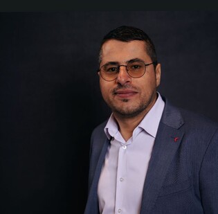 Man in a suit wearing glasses 