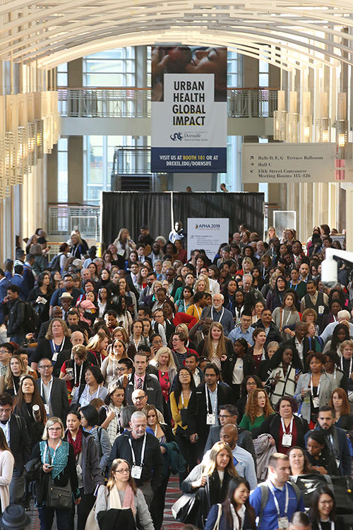 crowd of Annual Meeting attendees pouring out of opening session
