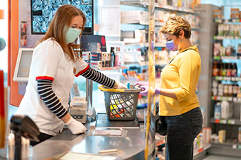 women at grocery store checkout